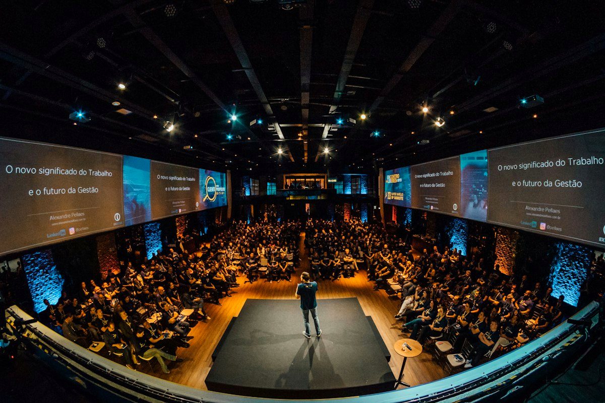 Keynote speaker on a large conference stage