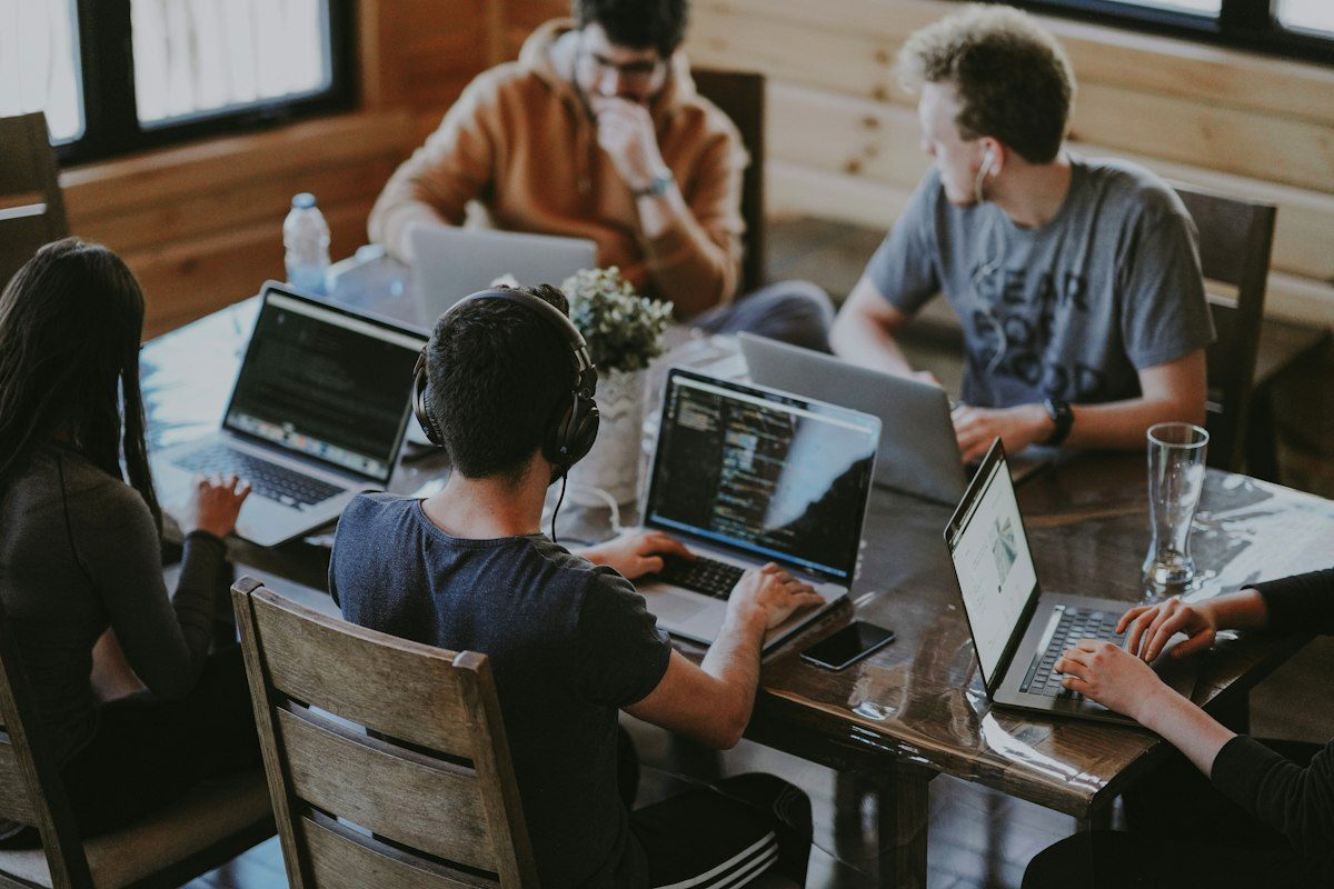 Team collaborating on a slide deck around a table